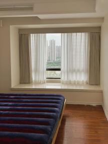 Bay window with drapery and sheer, finished installation